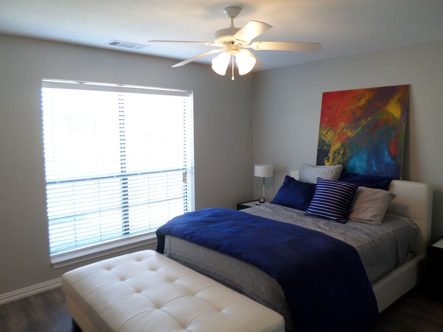 Master bedroom offers modern design, with convenient nightstands and lots of natural light