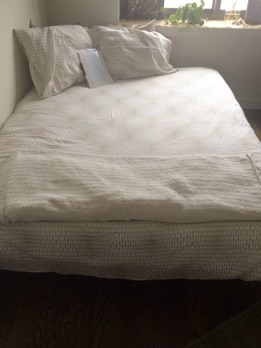 This is a picture of the new queen sized bed in the guest room with 4 pillows, fresh sheets, as well as access to extra linens. Very bright in the room so this isn't such a great photo- guests have told us it's much better in person.