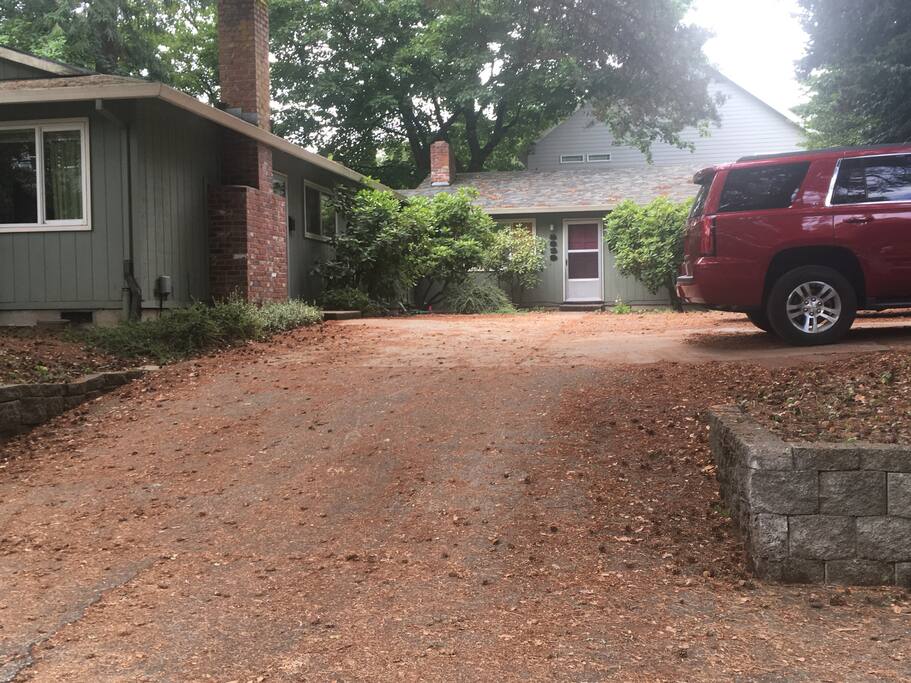Single level apartment part of triplex surrounded by trees