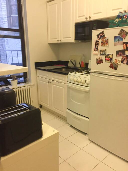 Fully equipped kitchen with all amenities including microwave, electric kettle, toaster, gas stove, full size fridge