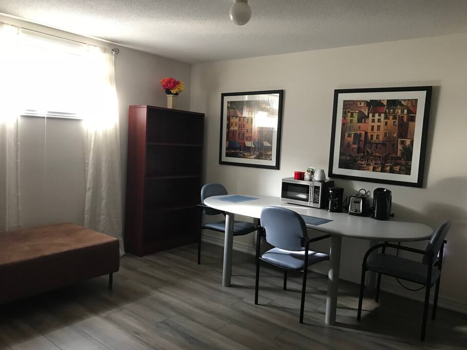 Your very own private living and dining space, with sofa and book shelf. Dining area complete with microwave, coffee maker, toaster, electric kettle.