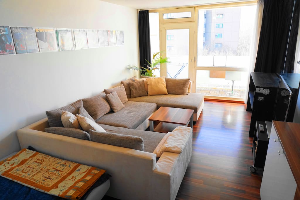 A warm atmosphere is created in this room and is equipped with a modern TV and sound system.