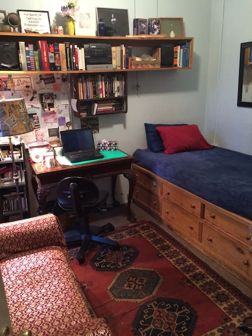 Guest room has a large desk for working -- and a settee for relaxing