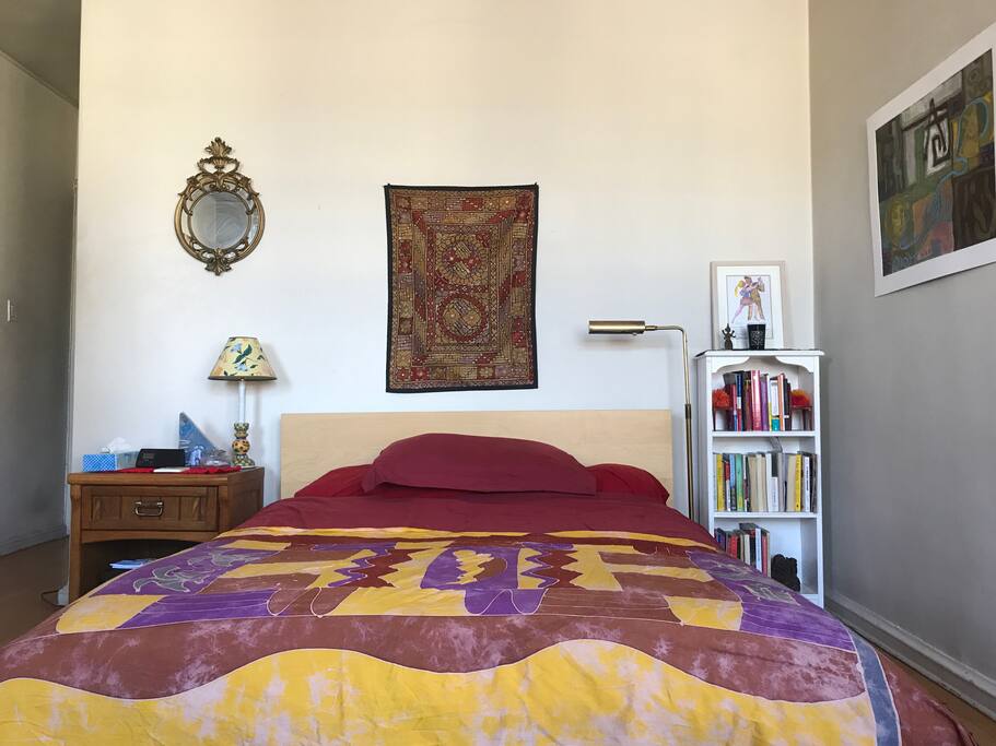 This is what it looks like when you crawl into bed. The alarm clock on the wooden nightstand also has a USB port and speaker cable for phone-charging and music-listening purposes.