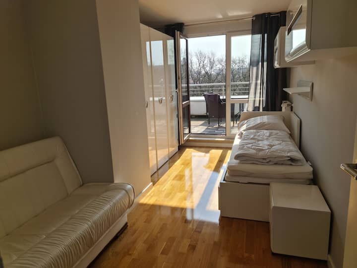 The room with a sofa bed and right the bed to undress for 2 people from Ikea. The terrace is just about for the morning sun 