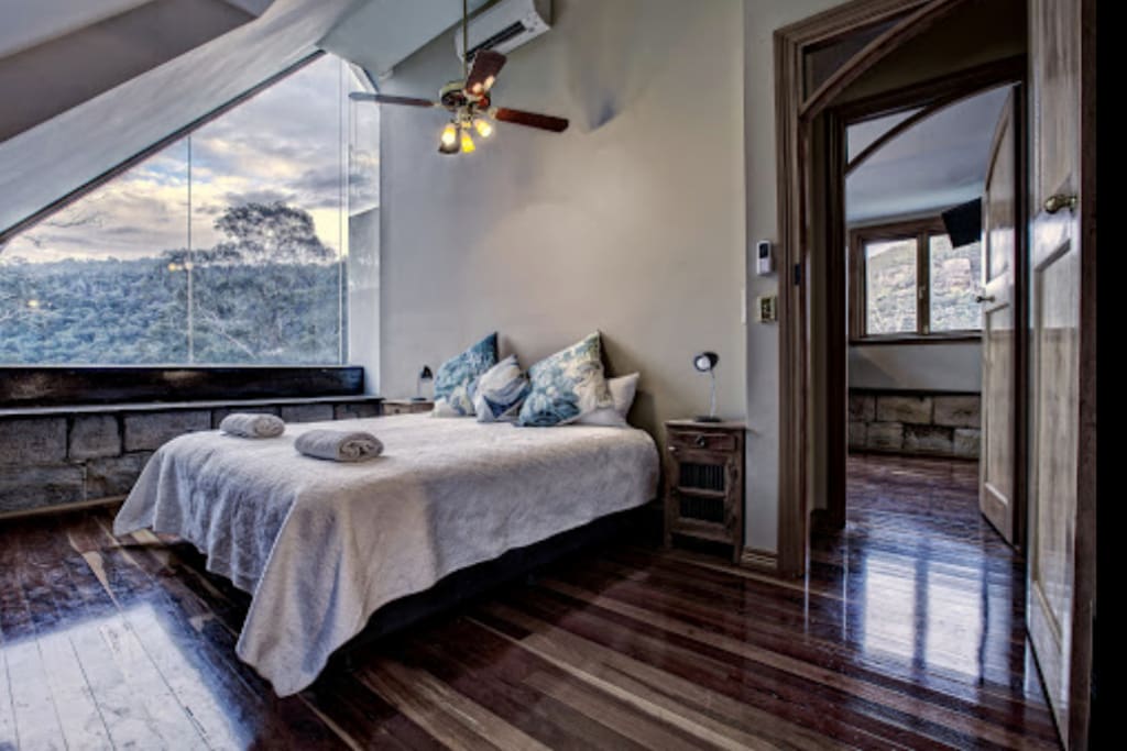 King Size Bed - view of the treetops and mountain during the day and the stars and moon at night.