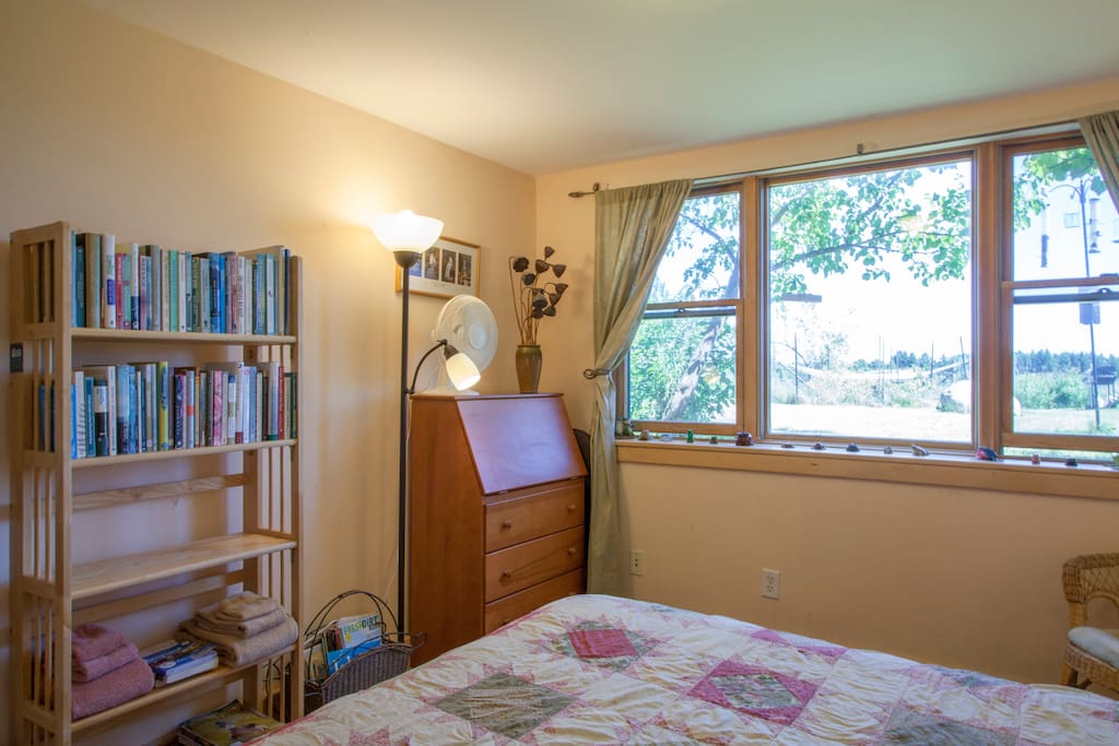 Large south-facing windows bring in lots of light, making this room bright. A reading chair next to the windows is the ideal place to look through all of our resources.