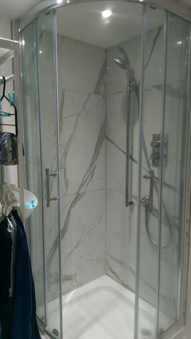 Well-maintained guest toilet and shower.