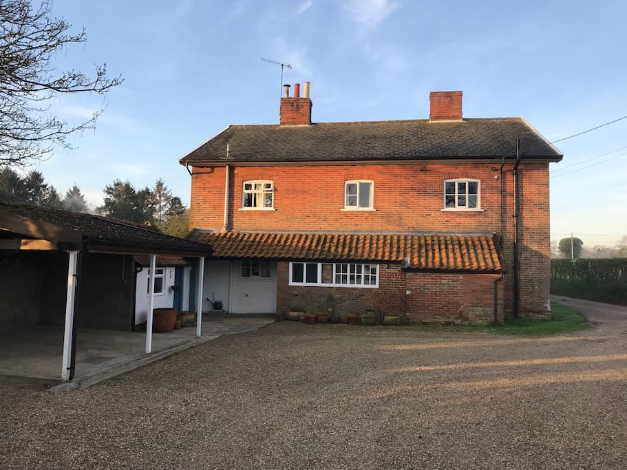 The house from the rear with ample, private parking including garages
