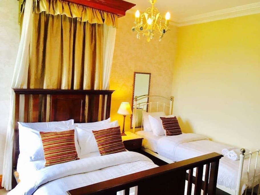 Double bed and single bed with white cotton rich bed linen with 100% white cotton towels bathrobes and flip flops free for guests to use