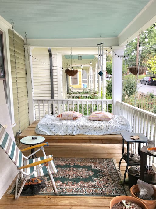 Our big front porch offer multiple seating options including the hanging bed!