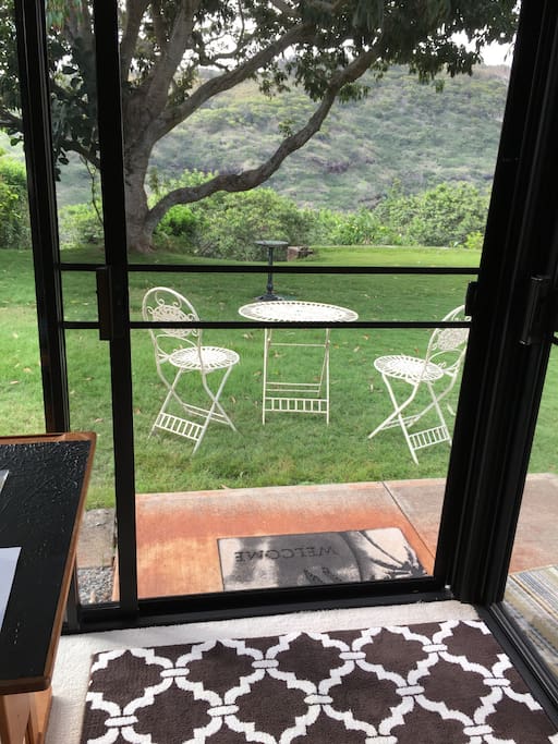 The table and chairs are located by the sliding door.