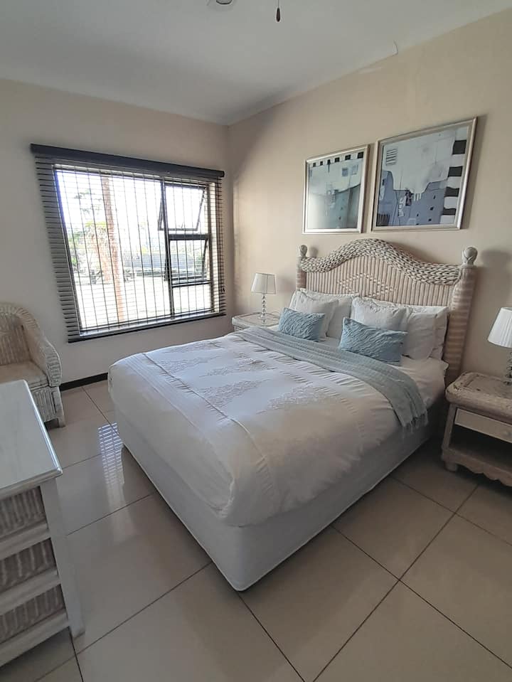 Bedroom 4, has a queen bed with a private separate bathroom, ceiling fan, TV.