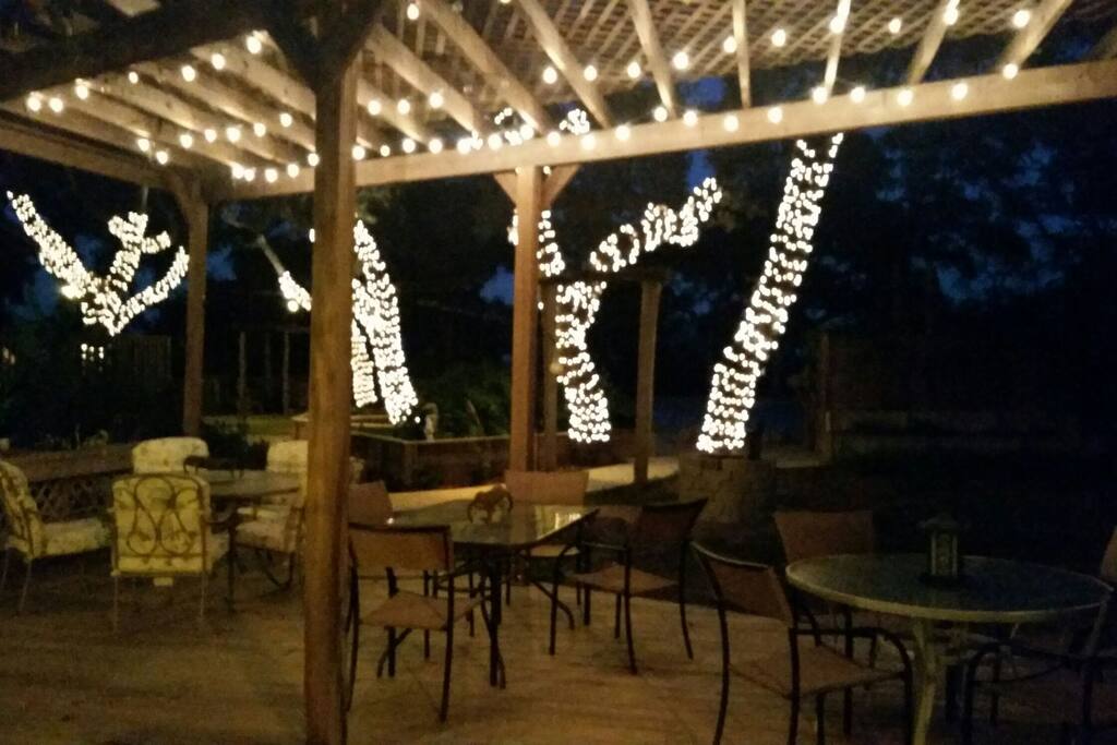 Patio deck with outdoor seating, with romantic lighting.