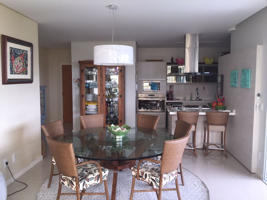 FOTO DA SALA E DA COZINHA DO APARTAMENTO 4001, VILA 4, DO CONDOMÍNIO COSTÃO DAS GAIVOTAS, NA PRAIA DO SANTINHO. O APARTAMENTO É TÉRREO, DE FRENTE PARA UMA PISCINA E COM VISTA TOTAL DO MAR. O APARTAMENTO POSSUI TRÊS SUITES.