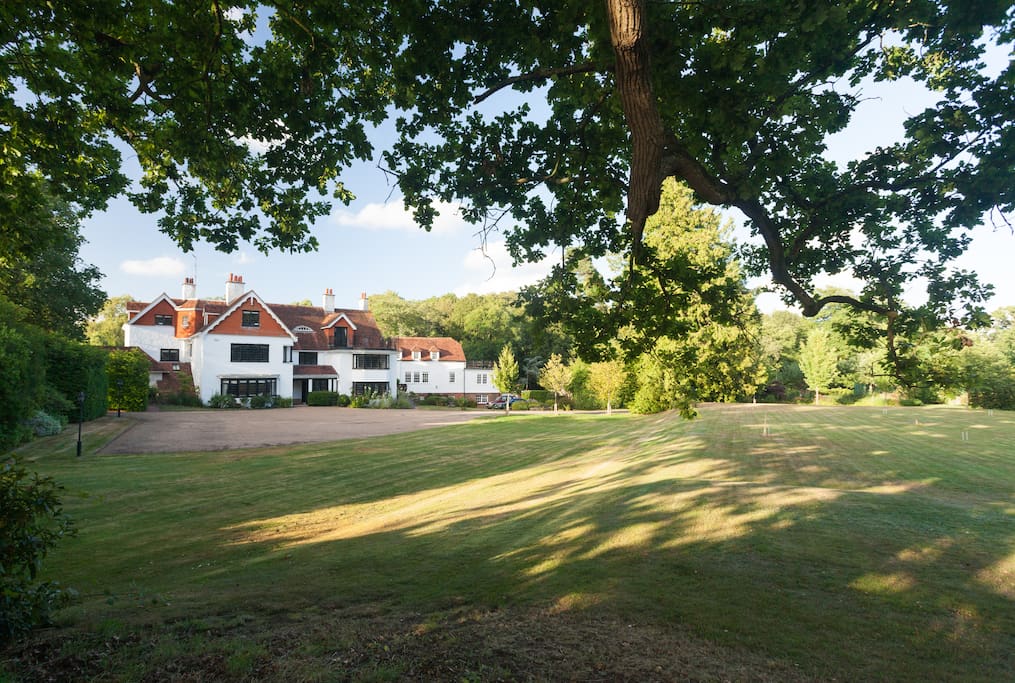 Front of house with croquet and tennis