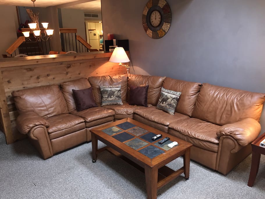 The leather couch in the living room converts to a double bed.