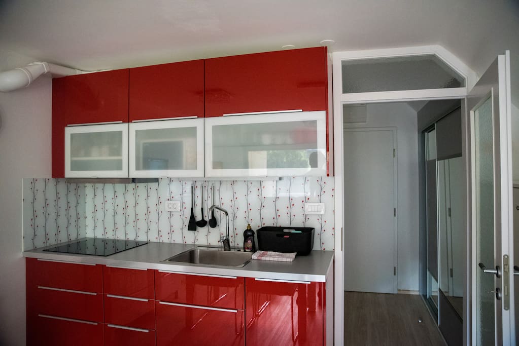 Kitchen with four stoves, fridge, sink and dish washer