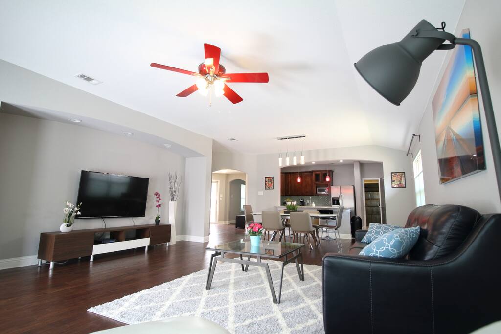 Living room with 1 sofa bed, 1 lounge chair and 65" smart TV
