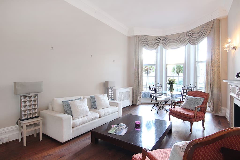 The classically style, spacious lounge, dining area and balcony with view over the garden in front