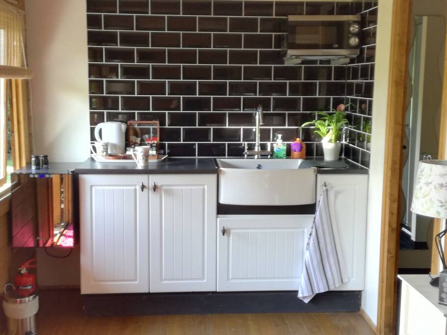 The Kitchen area, there are tea and coffee making facilities, hot cold water , fridge , plates, side plates, dishes with cutlery provided, wine glasses and juice glass ..pedal bin for rubbish. Tea towels ,table cloth and napkins provided. Cleaning products provided.
