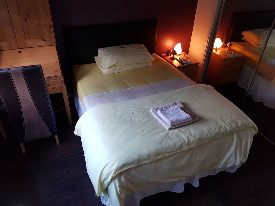 Double bed with complimentary tumble stone crystal and description card on pillow (1 crystal per guest)