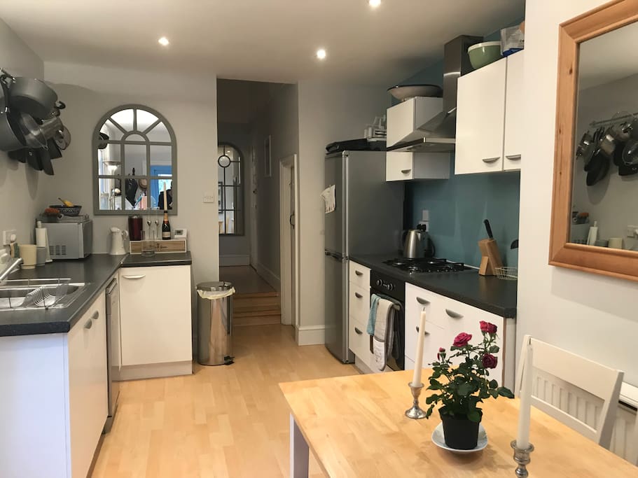 Kitchen with dining table that sears four people, large fridge freezer, gas hob, electric oven, microwave, dishwasher, toaster and kettle