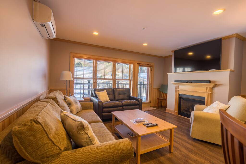 Living room has a Queen sleep sofa, gas fireplace, flatscreen cable TV and balcony.