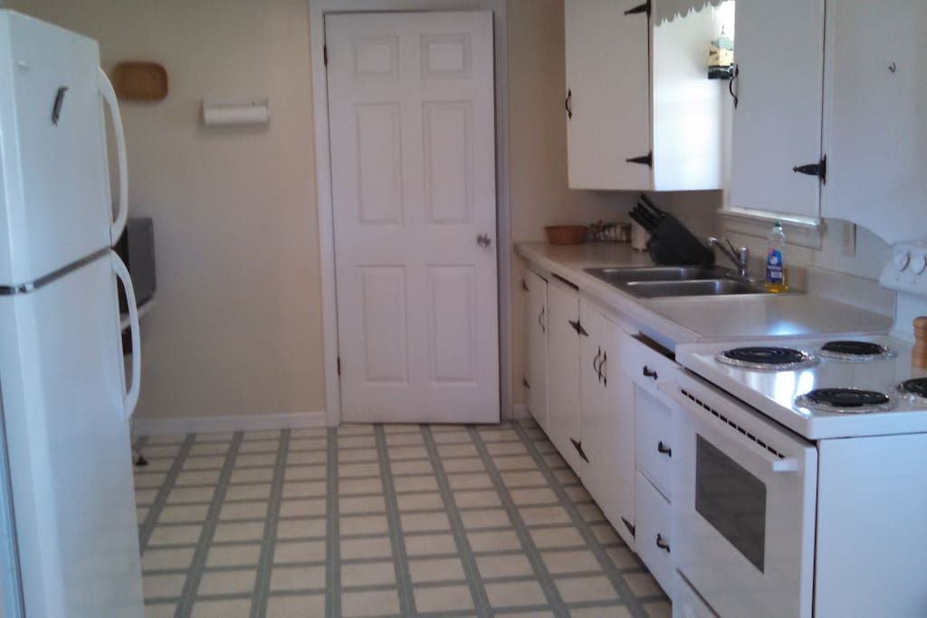 Kitchen and door to half bath