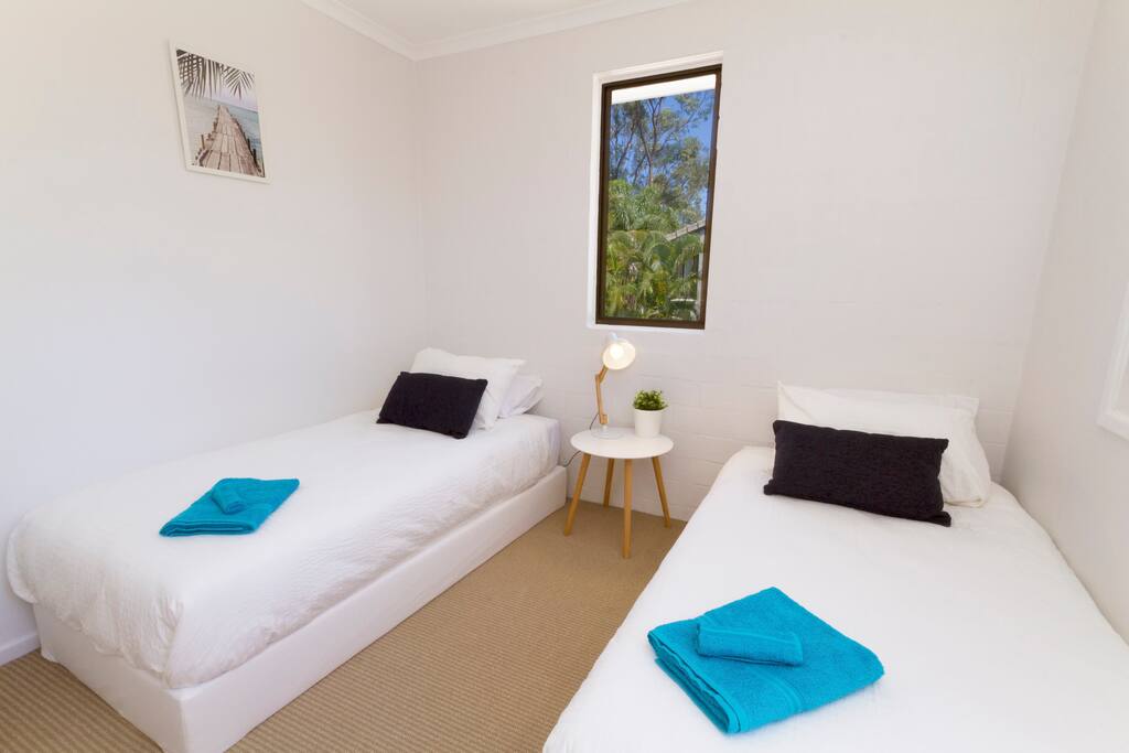 2nd bedroom: Two single beds (or make up as one Queen bed) with large wardrobe and desk.