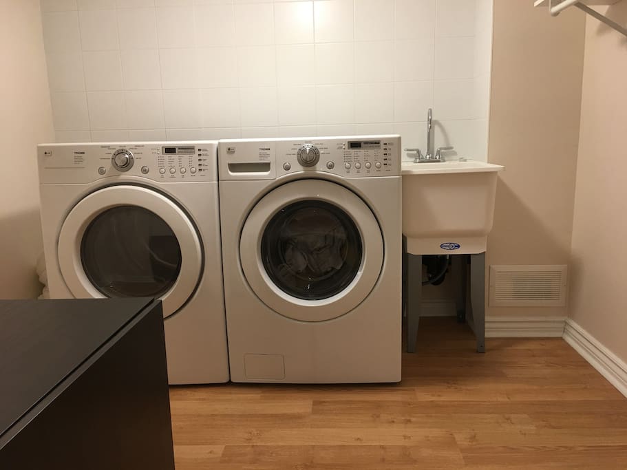 Fully stocked washer and dryer, as well as laundry sink