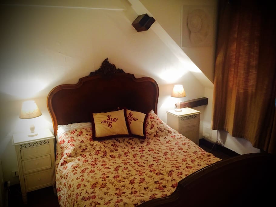 2nd guest room with traditional french double bed and views over garden