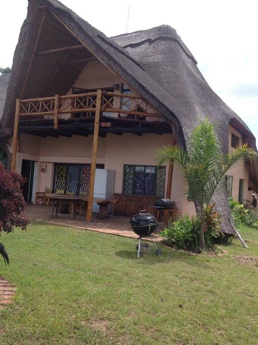 Main house front with balcony from 1st floor lounge overlooking pool