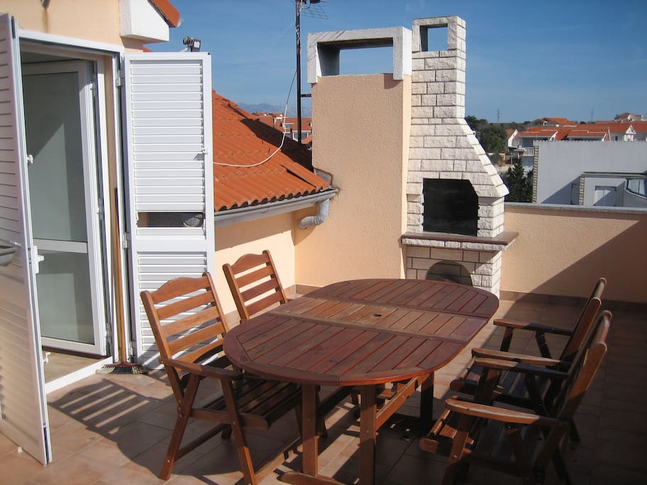 Large balcony with table, chairs and BBQ