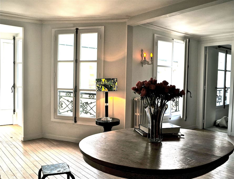 the main room has three large windows facing south east onto a courtyard