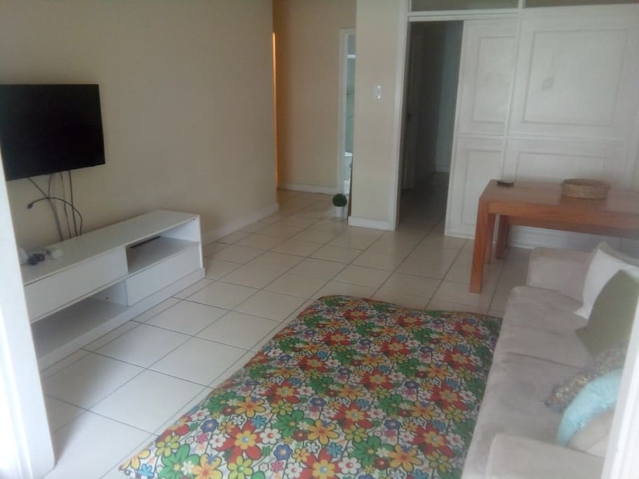 smart TV de 42" e Wi-Fi e entrada para o quarto, banheiro e corredor que leva à cozinha