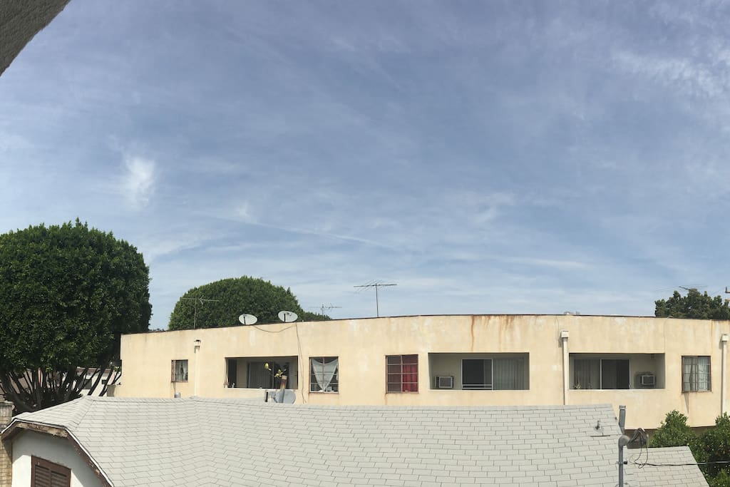 View from the balcony.. blue skies - and there is a house between you and another apt bldg which is very rare