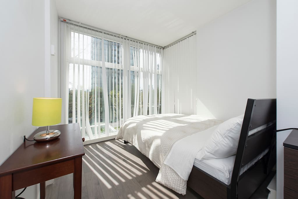 The full-length windows in this bedroom allow for plenty of natural light to come in