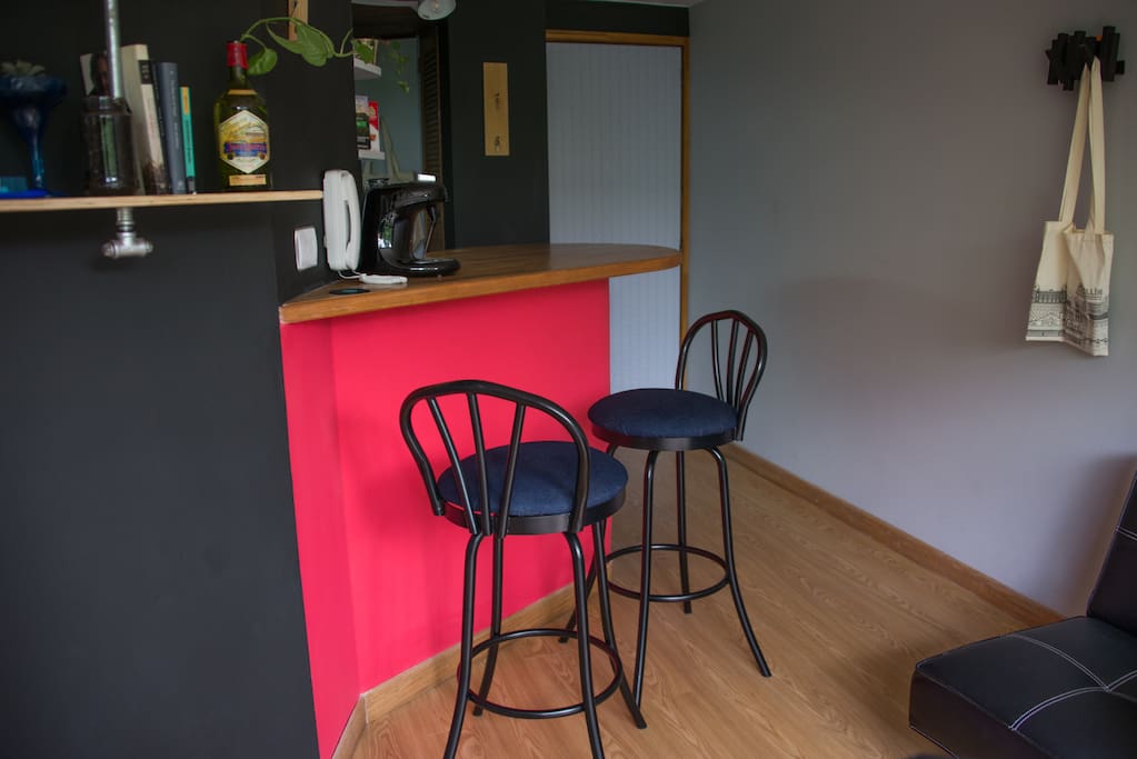 Kitchen bar table and studio entrance.