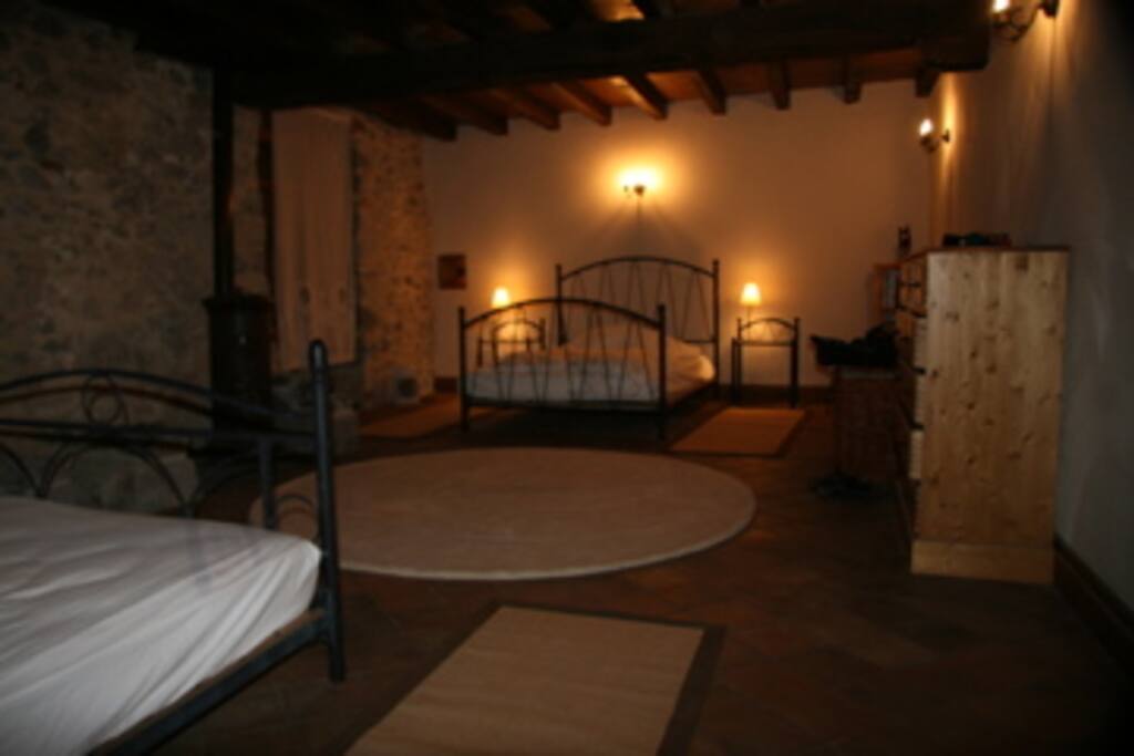 Master Bedroom, 2 double beds & wood burning stove.