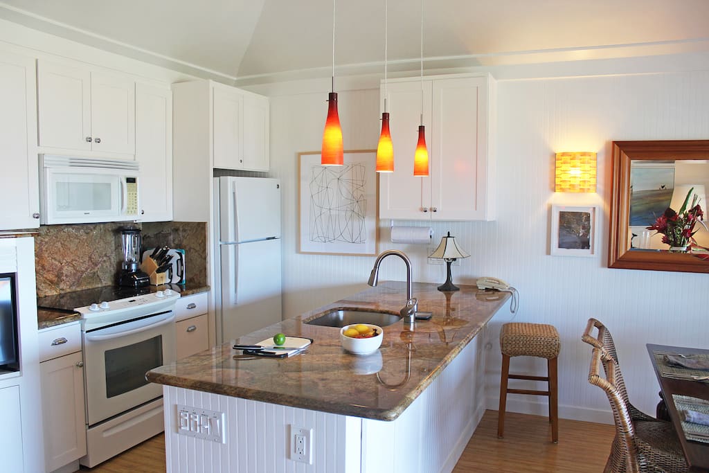 The kitchen has granite countertops and is fully furnished