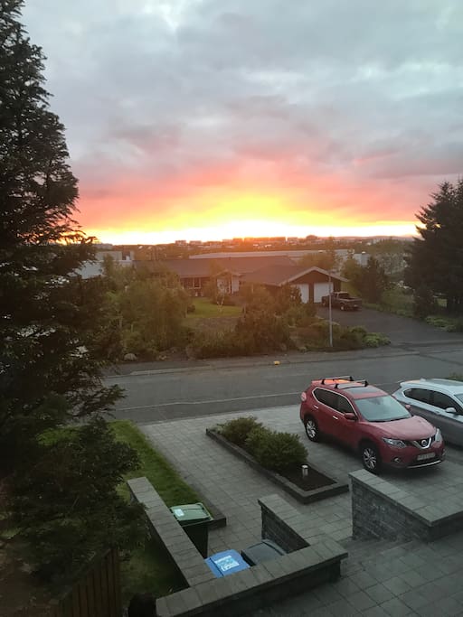 The Icelandic summer midnight sunset seen from the living room window