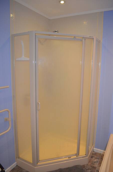 Private bathroom with bath and shower