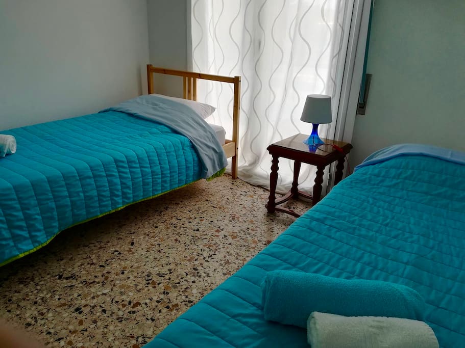 Room with a twin bed and an extra bed.