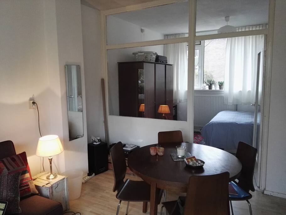 Living room and access to bedroom. There is e door that can close, but the wall is partly made of glass.