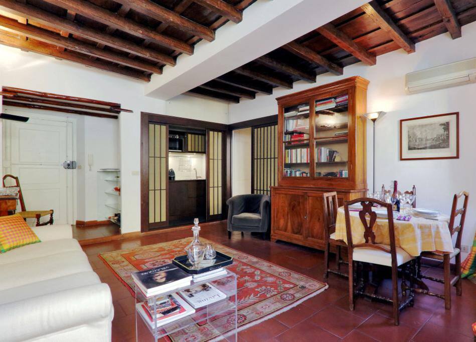 The living room contains a white double sofa-bed, a flat screen TV and is separated from the rest of the house, guaranteeing a good nights sleep.