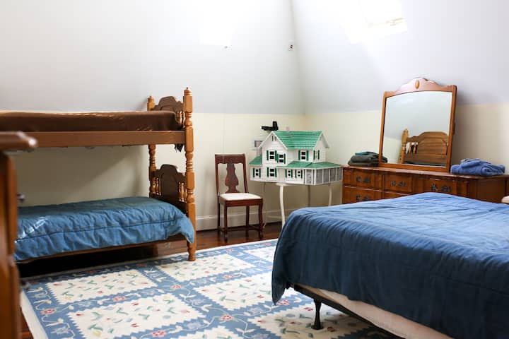 large open room on the third level with bunk beds and a full bed.