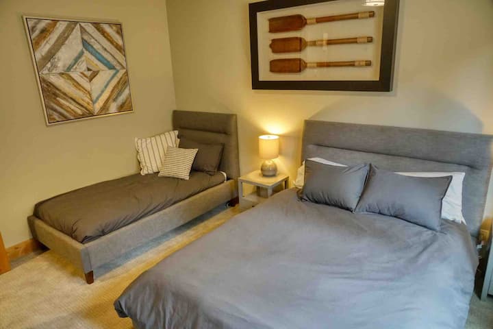 Downstairs bedroom with queen and twin bed.