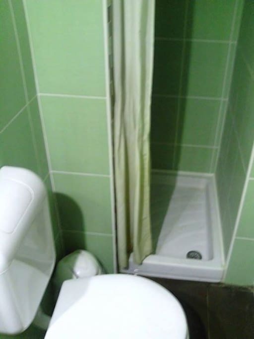 There are bed, shelf, drawer and small bathroom with sink, toilet and shower upstairs on the gallery.