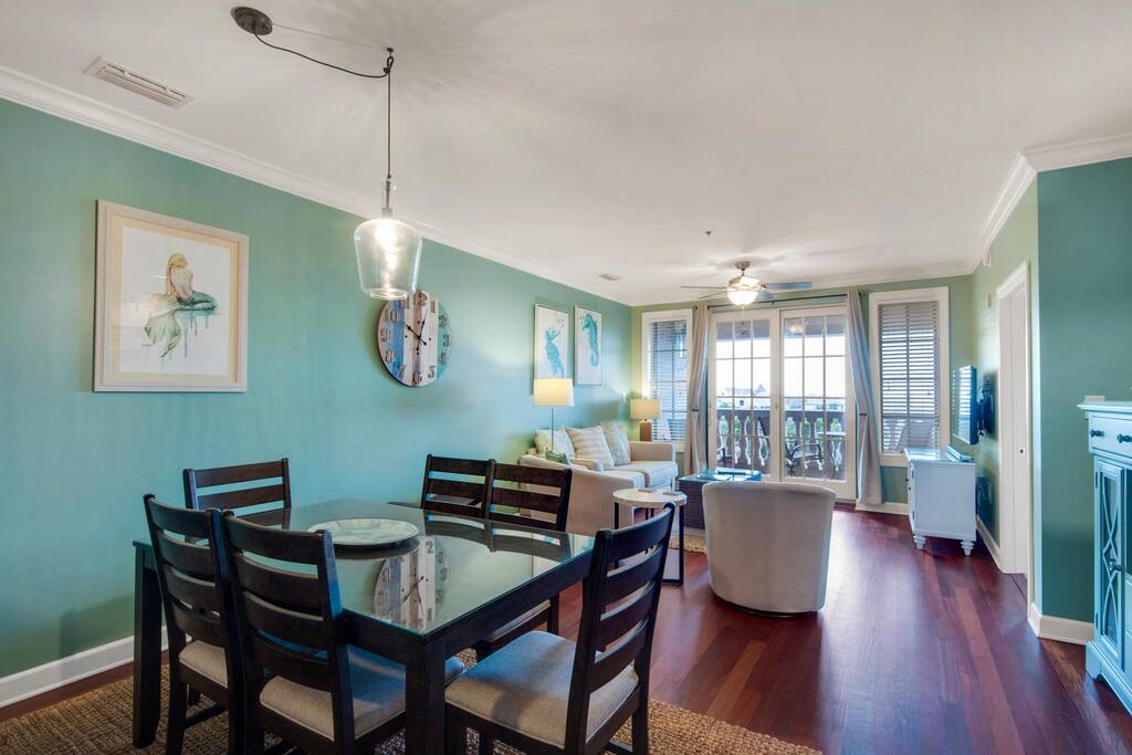 The living and dining area is beautifully designed for comfort and enjoyment. There is a table for six as well as four stools at the bar.